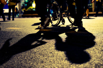 Low section of people with bicycle on street