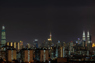 Illuminated buildings in city at night