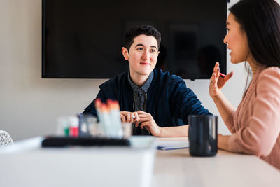 Business colleagues planning strategy at table in board room