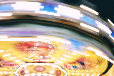 Light trails in amusement park at night