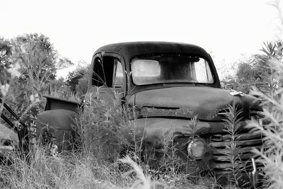 Abandoned car on field