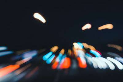 Close-up of light trails against sky at night