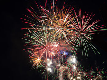 Low angle view of firework display at night