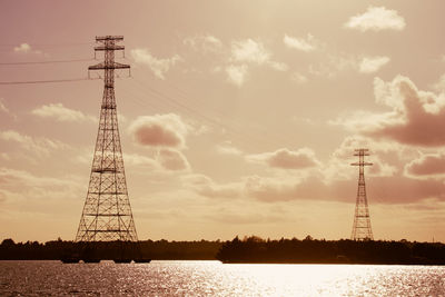 Low angle view of communications tower against sky during sunset