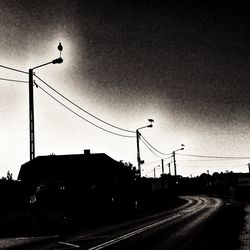 Street light on road against sky