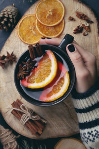 High angle view of hand holding fruit on table