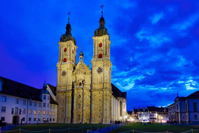 Historic building against blue sky at night