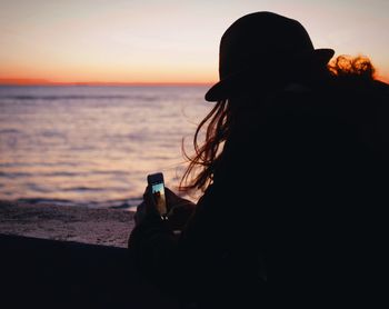 Close-up of silhouette woman on beach