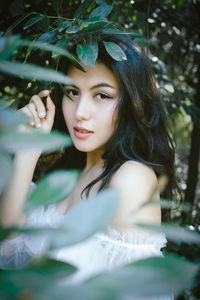 Portrait of young woman in forest