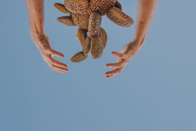 Low section of person against clear blue sky