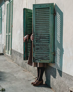 Low section of woman standing on building