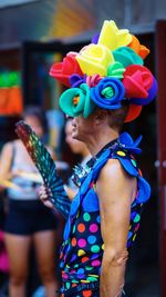 Portrait of woman holding multi colored umbrella