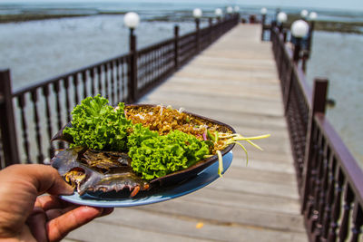 Close-up of hand holding food on table