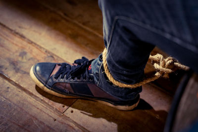 Low section of man tied on chair