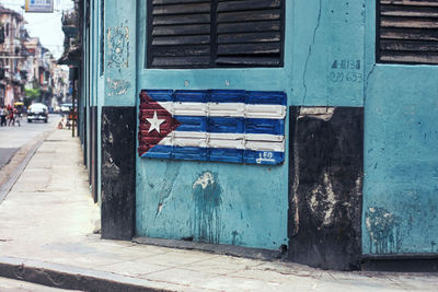 Cuban flag as a street marker. blue walls. louvre windows.