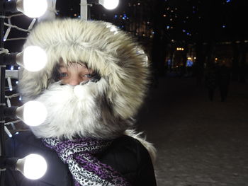 Portrait of girl wearing warm clothing during winter at night
