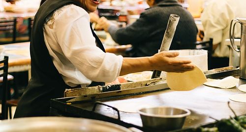 Midsection of man preparing food