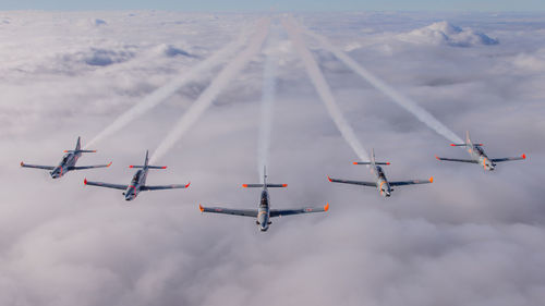 Low angle view of airshow against sky