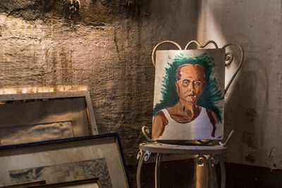 Statue on table against wall