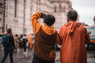 Rear view of people standing on street