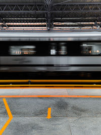 Blurred motion of train at railroad station