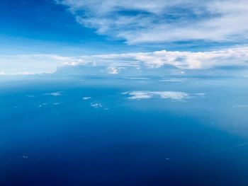 Aerial view of sea against cloudy sky