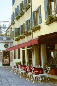 Chairs against buildings in city