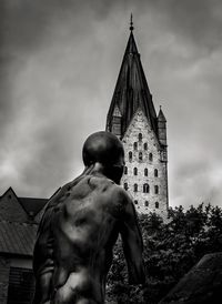 Low angle view of statue of liberty against cloudy sky