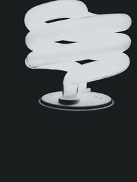 Close-up of white candle over black background