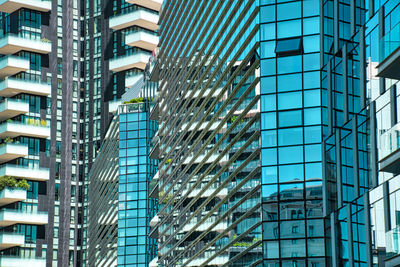 Low angle view of modern glass building in city