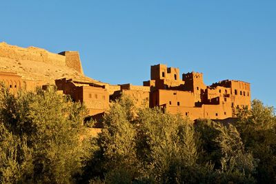 Low angle view of buildings against clear blue sky