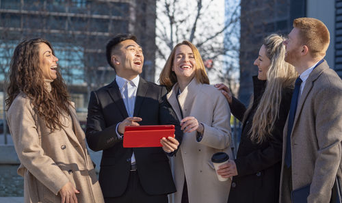 Portrait of smiling couple standing in city