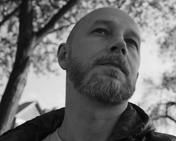 Close-up portrait of man against sky