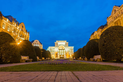 Statue in city at night