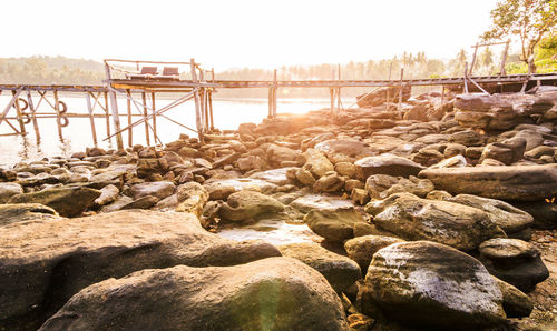 Rocks on beach against clear sky