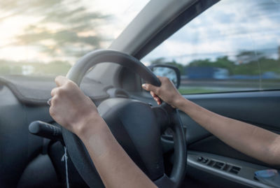 Cropped hands driving car