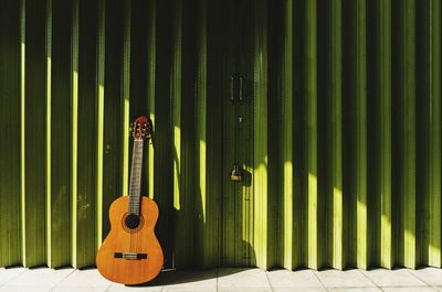 Full frame shot of guitar against wall