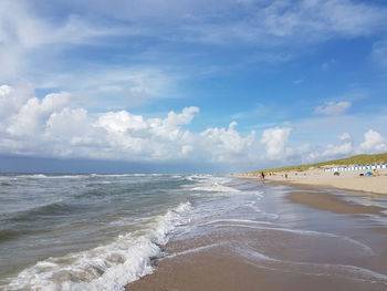 View of beach against cloudy sky