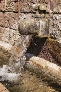 Close-up of water splashing against stone wall