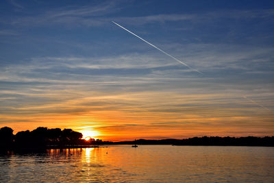 Scenic view of river against sky during sunset