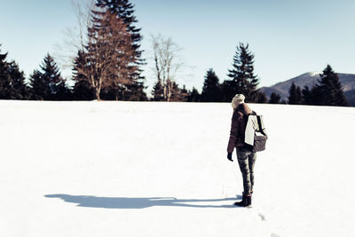 Full length of man standing on snow covered landscape