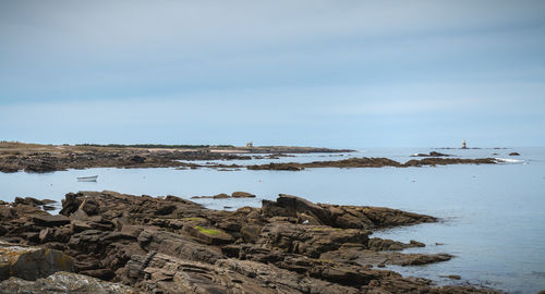 Rocks on beach against sky