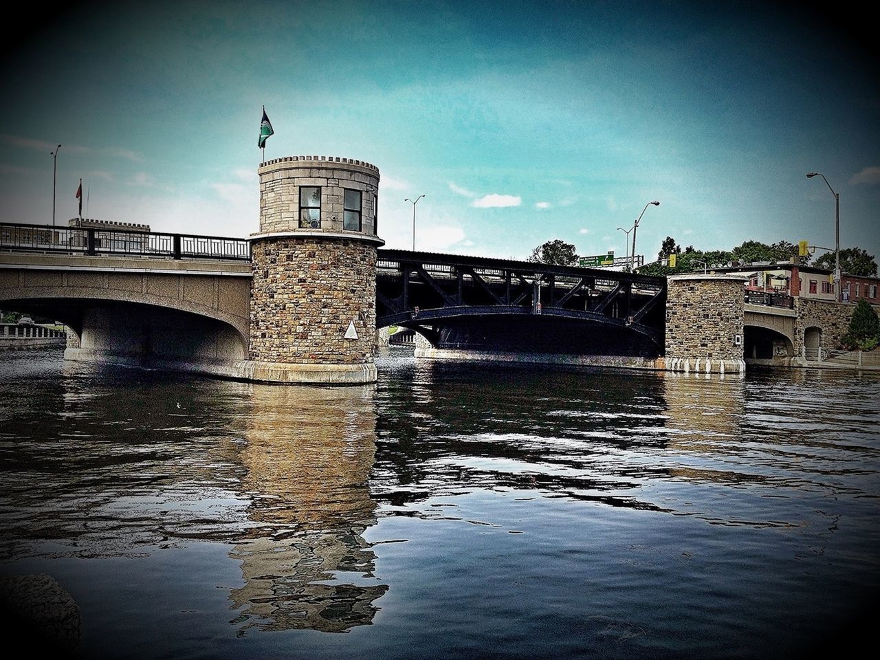 architecture, built structure, water, connection, building exterior, bridge - man made structure, waterfront, river, sky, reflection, arch, bridge, rippled, arch bridge, history, travel destinations, low angle view, outdoors, cloud - sky, day