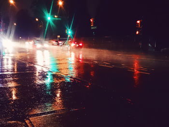 Reflection of illuminated lights in puddle