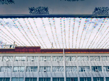 Low angle view of illuminated building against sky