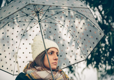 Portrait of a young woman in rain