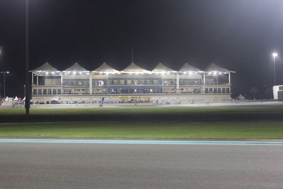 View of soccer field in city at night