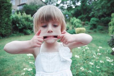 Portrait of cute girl holding plant