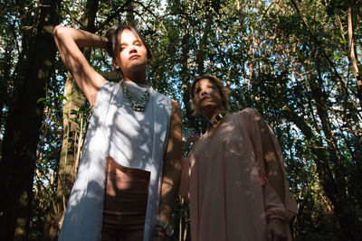 Fashionable beautiful woman posing in the forest