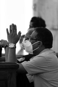 Man praying on church pews